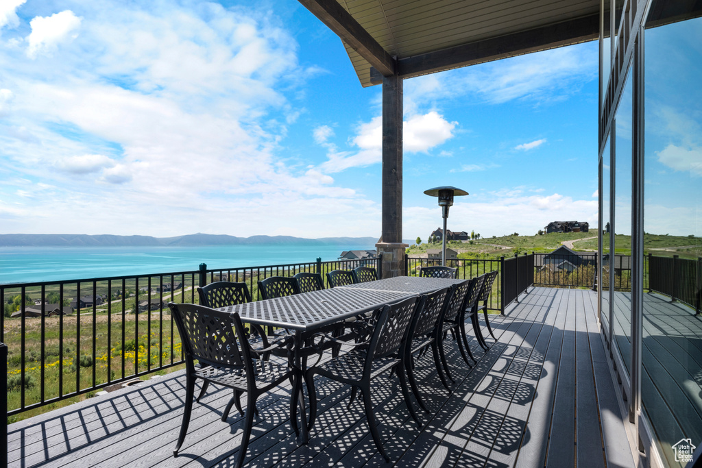 Wooden terrace with a water view and outdoor dining area