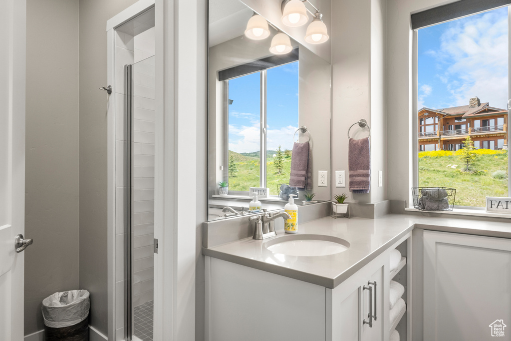 Full bath featuring vanity and a shower stall