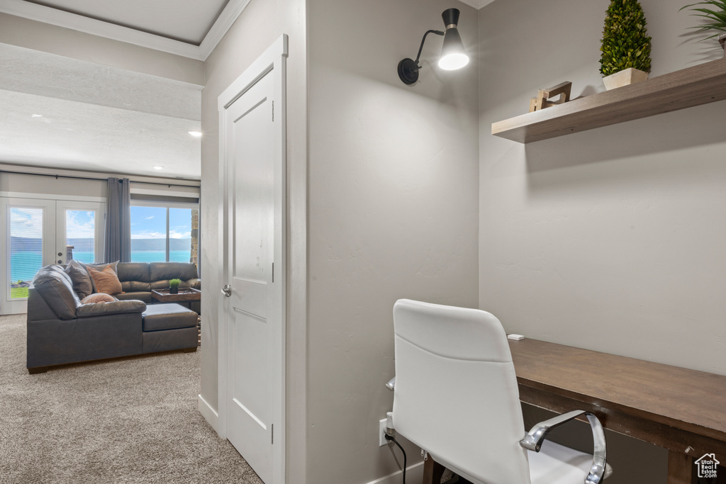 Home office featuring carpet, ornamental molding, and french doors