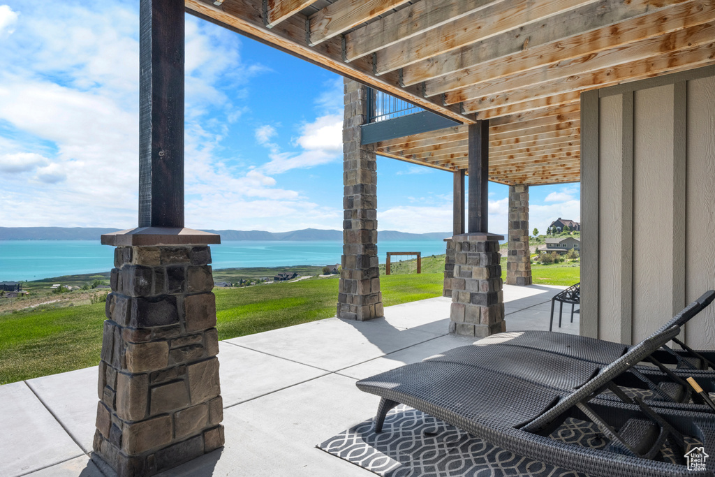 View of patio with a water view