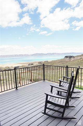 Wooden terrace featuring a water view