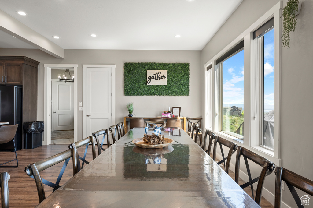 Dining space featuring recessed lighting, a chandelier, and wood finished floors