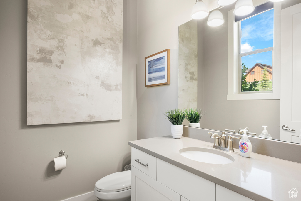Half bathroom with vanity and toilet