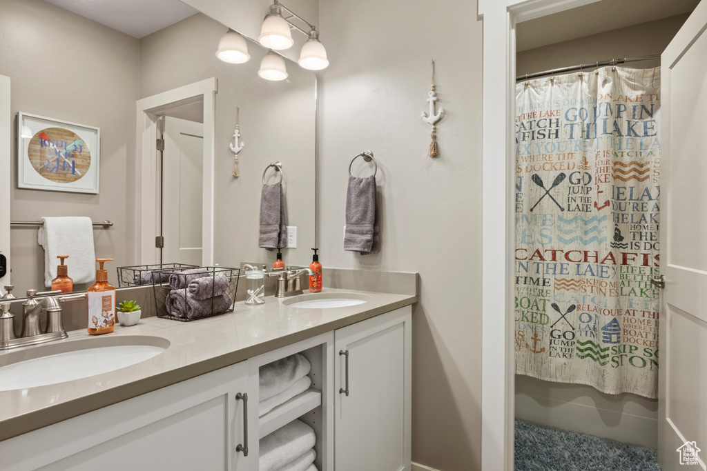 Bathroom with double vanity and curtained shower