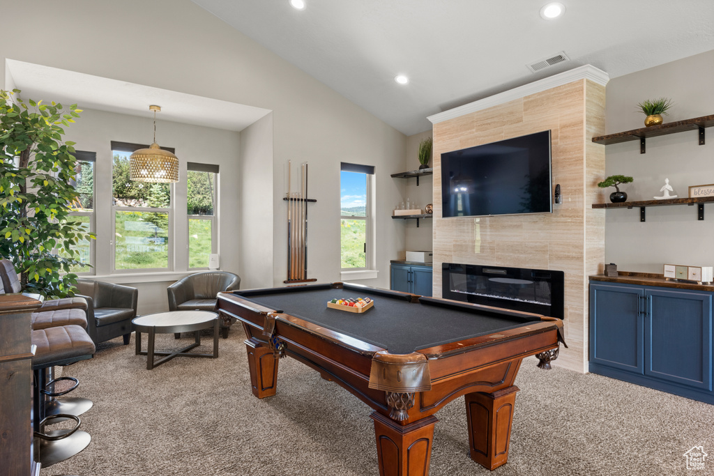 Game room with carpet floors, lofted ceiling, recessed lighting, a tiled fireplace, and billiards