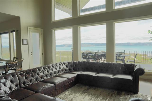 Living room with a towering ceiling and a water view