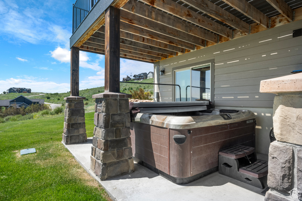 View of patio with a hot tub