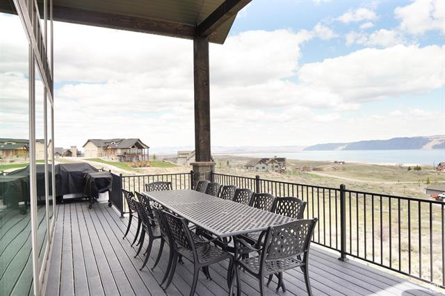 Wooden terrace with a water view and outdoor dining space
