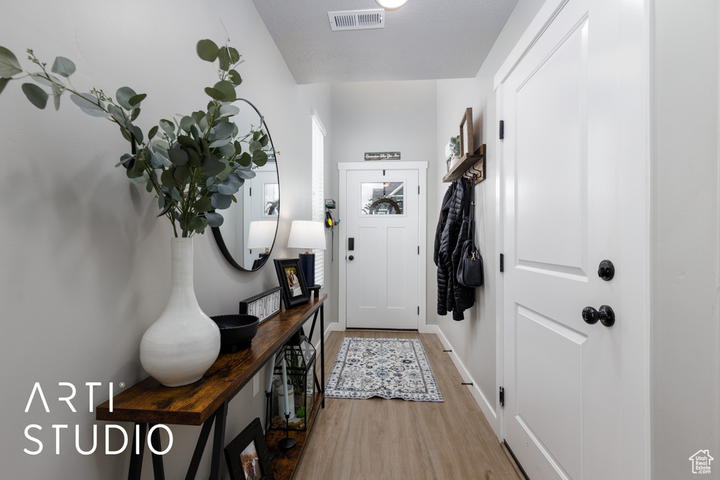 Entryway featuring wood finished floors and baseboards