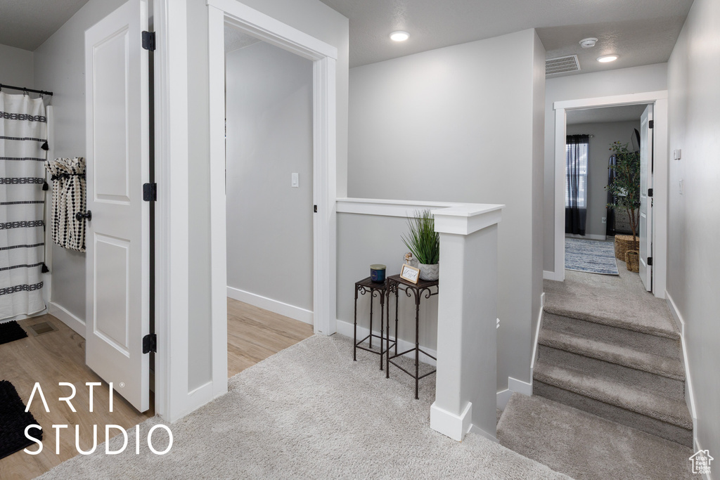 Corridor with carpet floors, baseboards, and recessed lighting