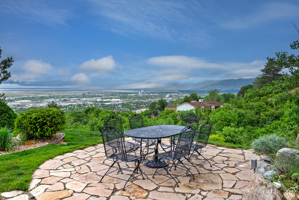 View of patio with outdoor dining area and a mountain view