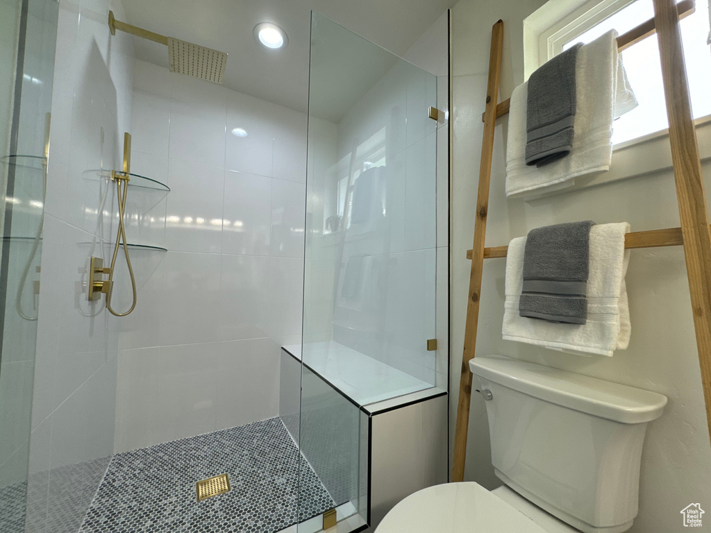 Full bathroom featuring toilet, walk in shower, and recessed lighting