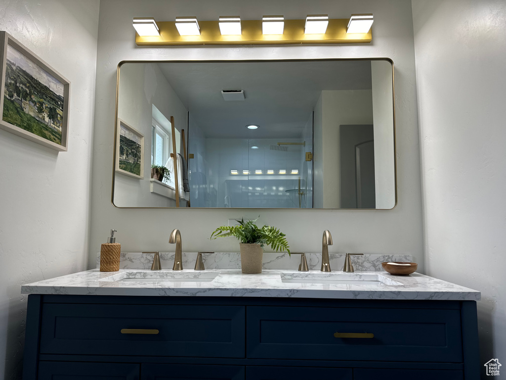 Bathroom with double vanity and a shower