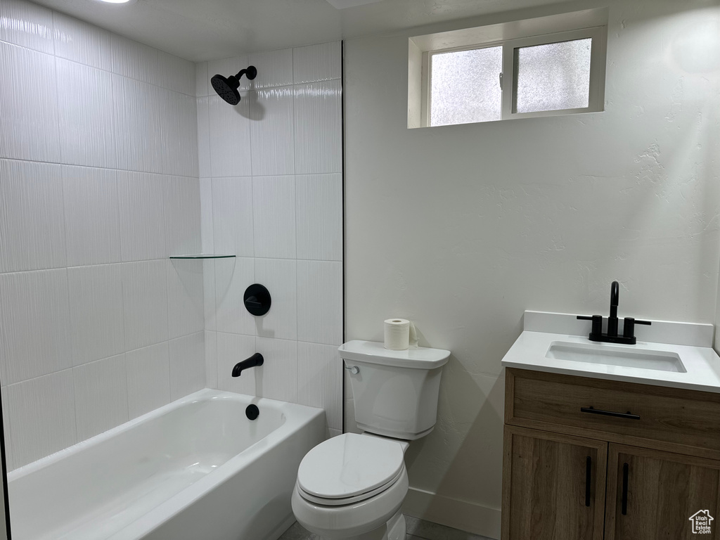 Bathroom featuring toilet, vanity, and bathing tub / shower combination