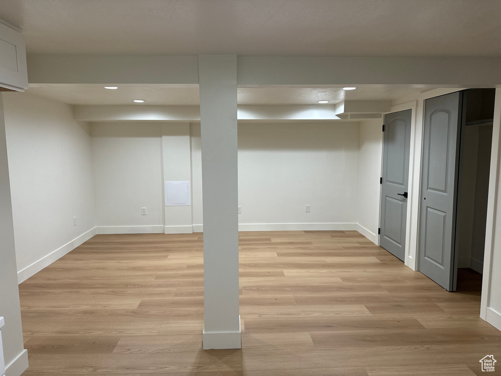 Finished below grade area with recessed lighting, baseboards, and light wood-style floors
