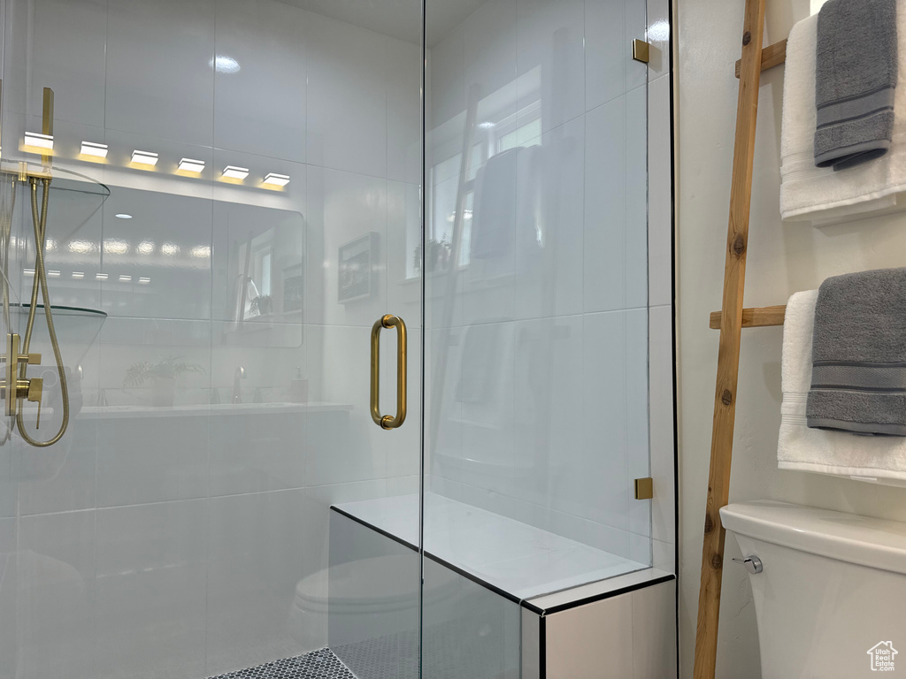 Full bath with toilet and a shower stall