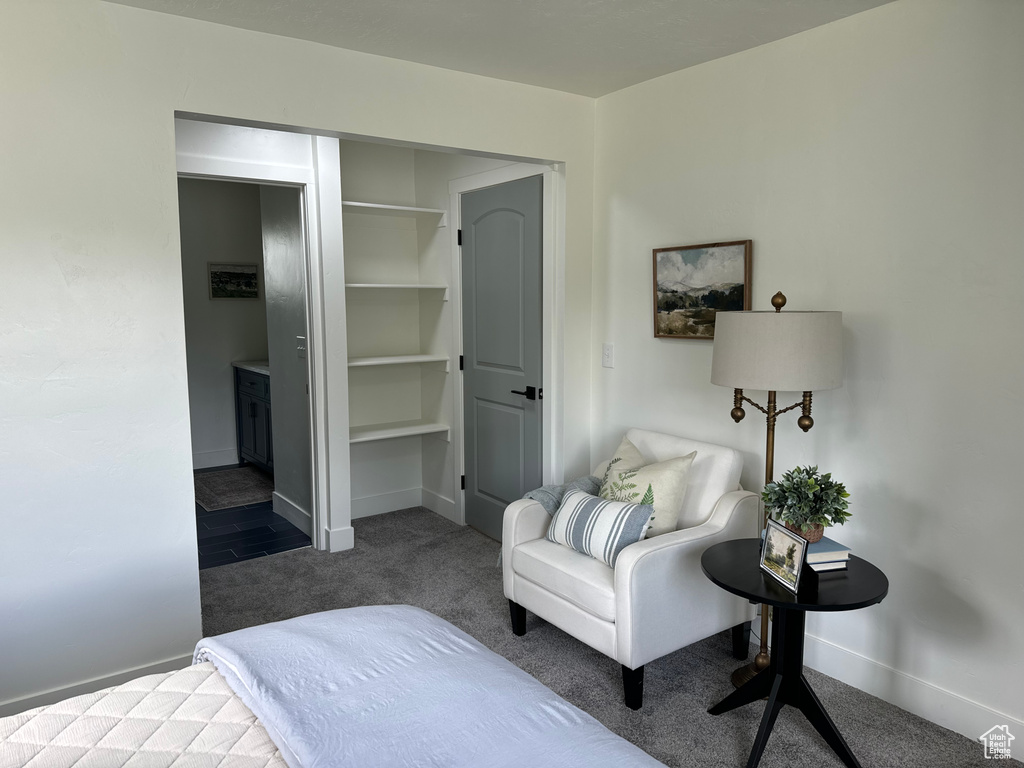 Bedroom featuring carpet and baseboards