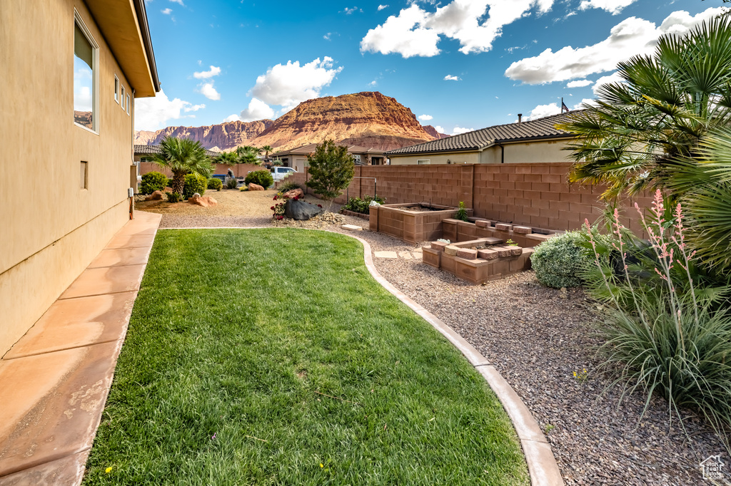 View of yard with a mountain view and a garden