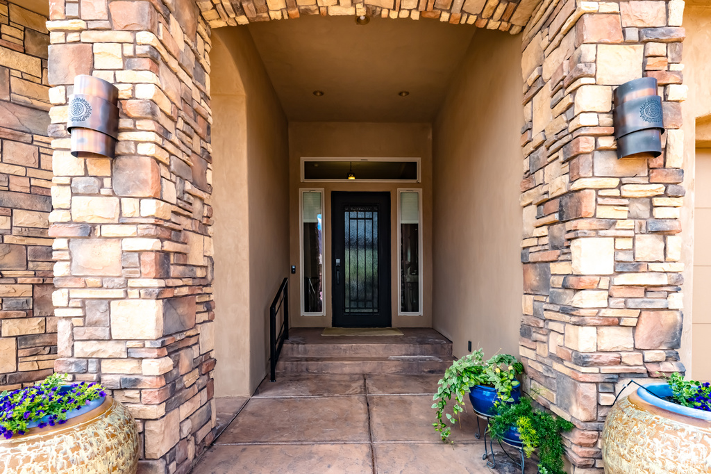 Property entrance featuring stone siding
