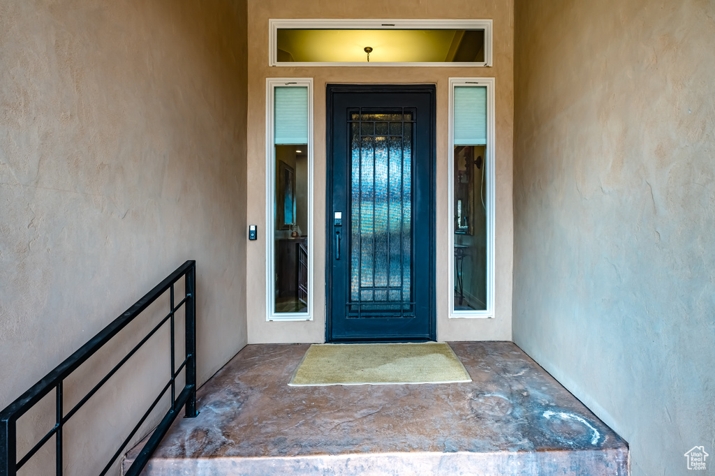 View of exterior entry with stucco siding