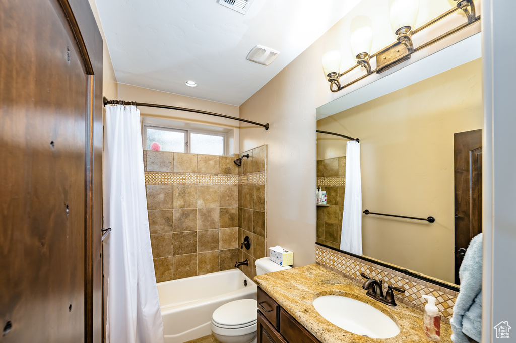 Full bath with toilet, shower / tub combo, and vanity