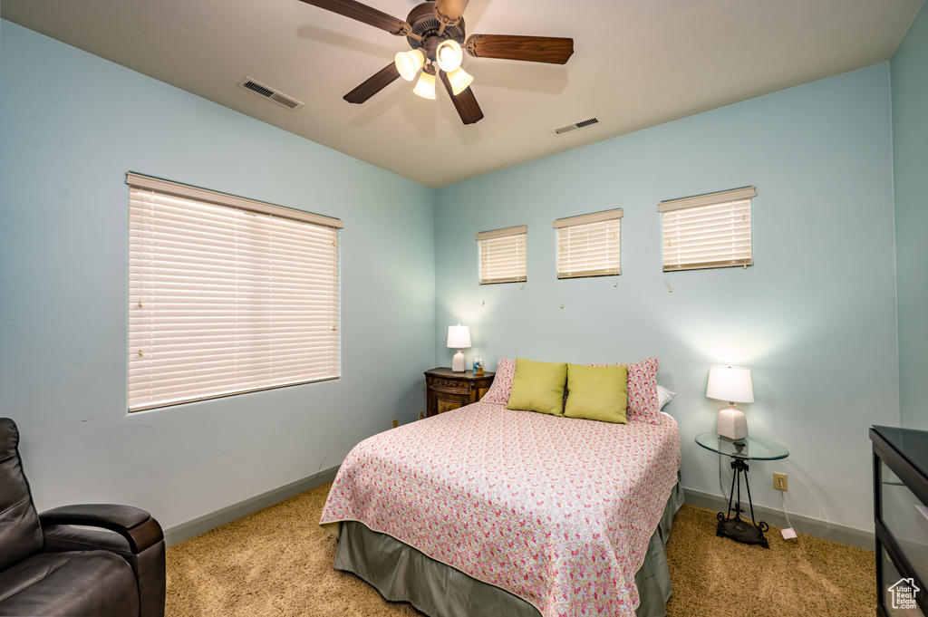 Bedroom featuring carpet, baseboards, and a ceiling fan