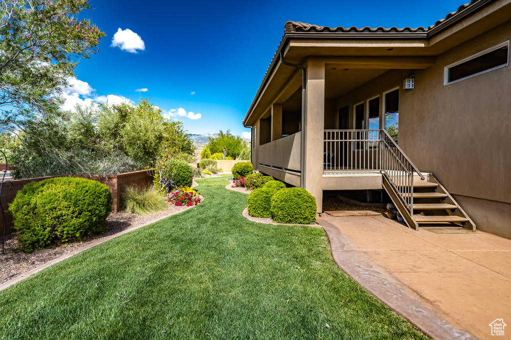 View of yard featuring stairs and a patio area