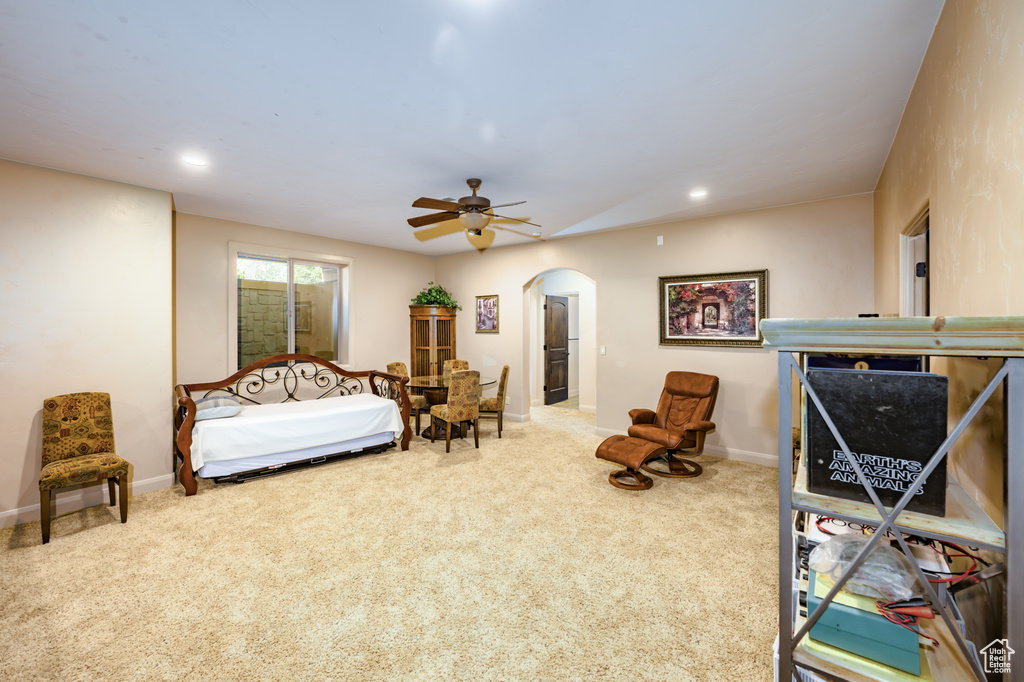 Carpeted bedroom featuring arched walkways, baseboards, recessed lighting, and ceiling fan