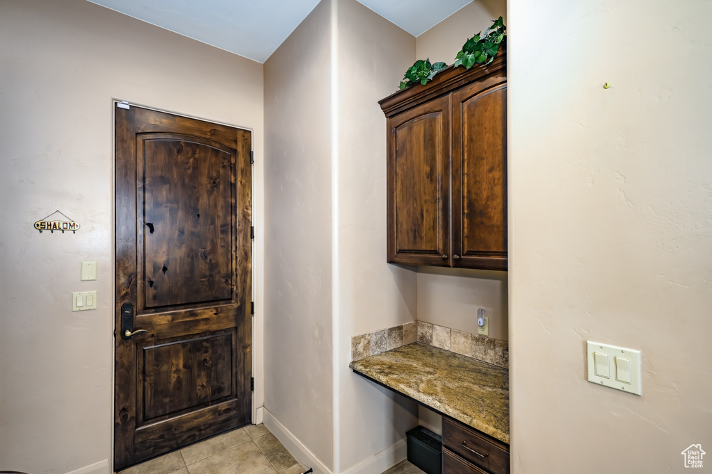 Entrance foyer featuring baseboards and light tile patterned floors
