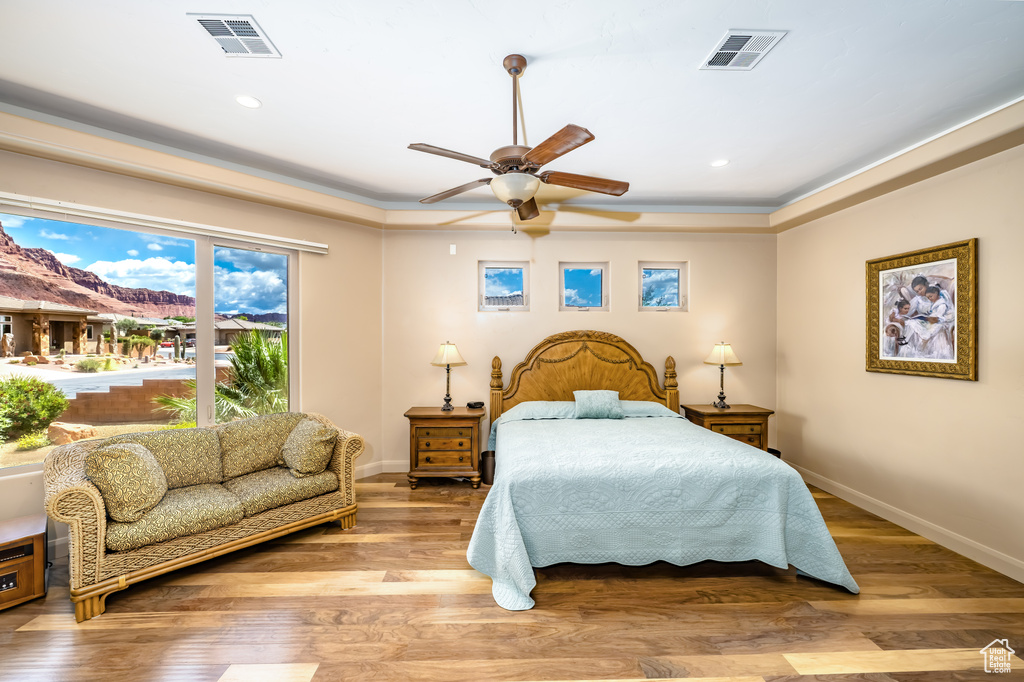 Bedroom with wood finished floors, baseboards, recessed lighting, and a ceiling fan