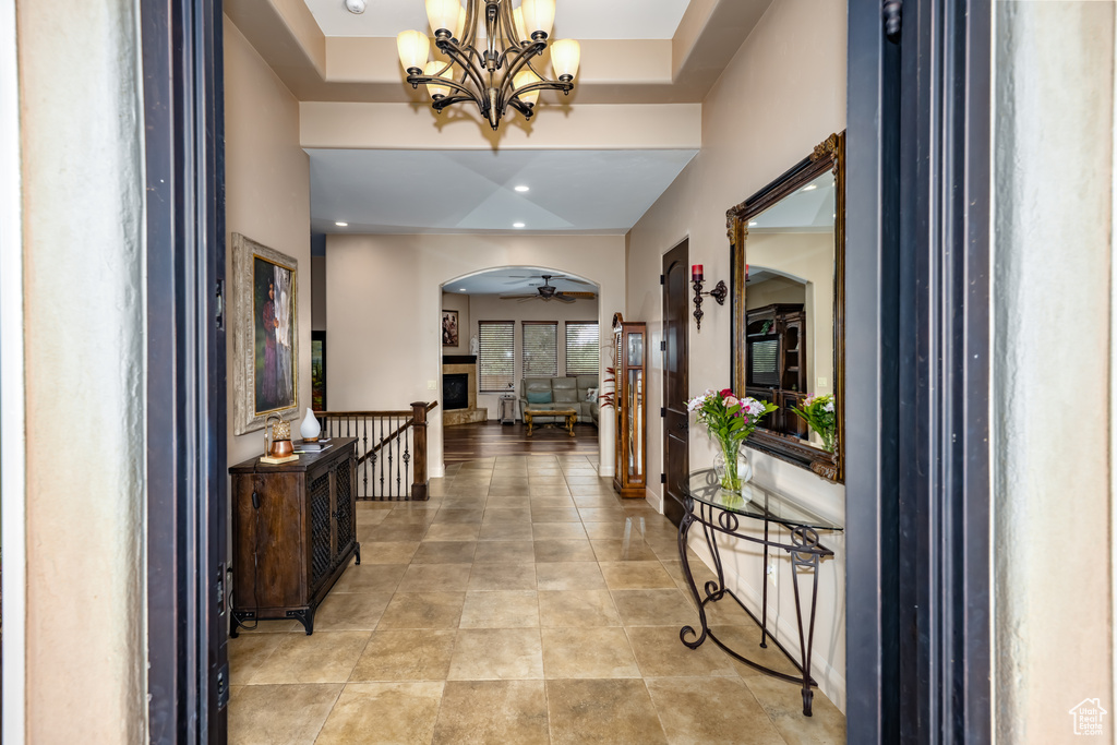 Hall featuring arched walkways, a chandelier, and recessed lighting