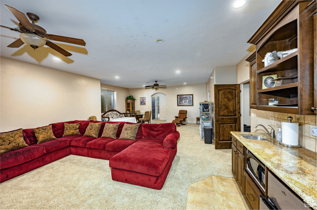 Living area with ceiling fan, light carpet, and recessed lighting