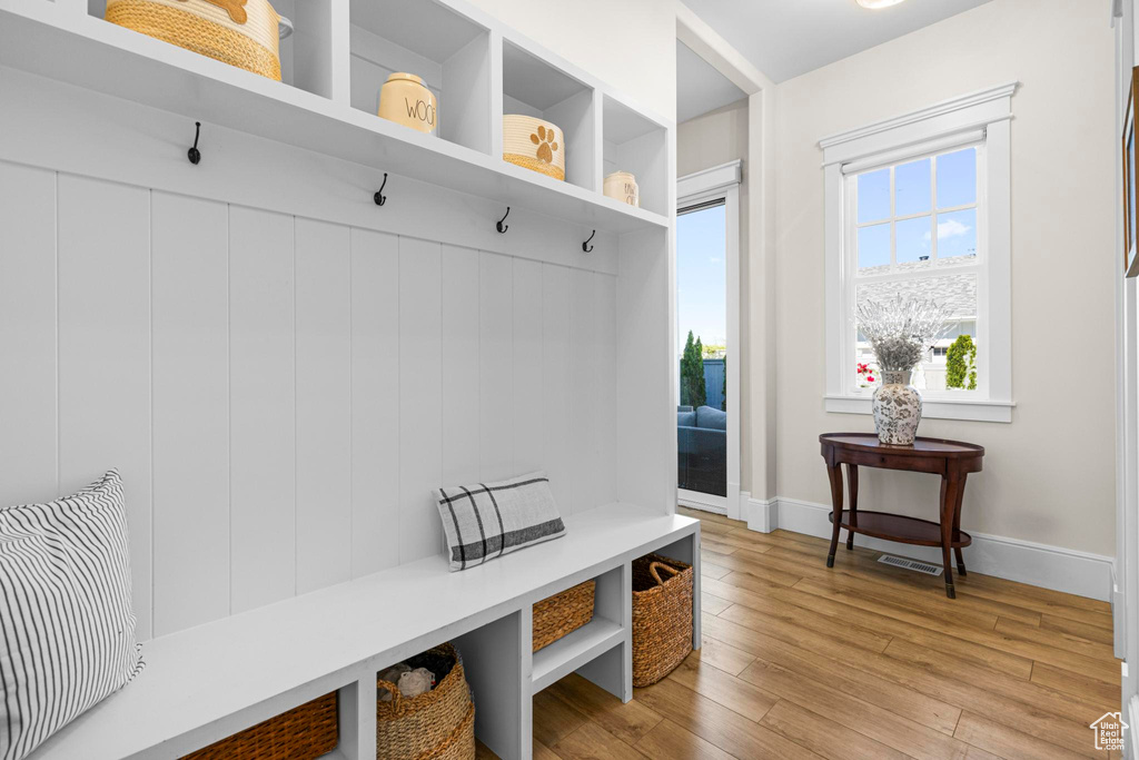 Mudroom featuring light wood finished floors and baseboards