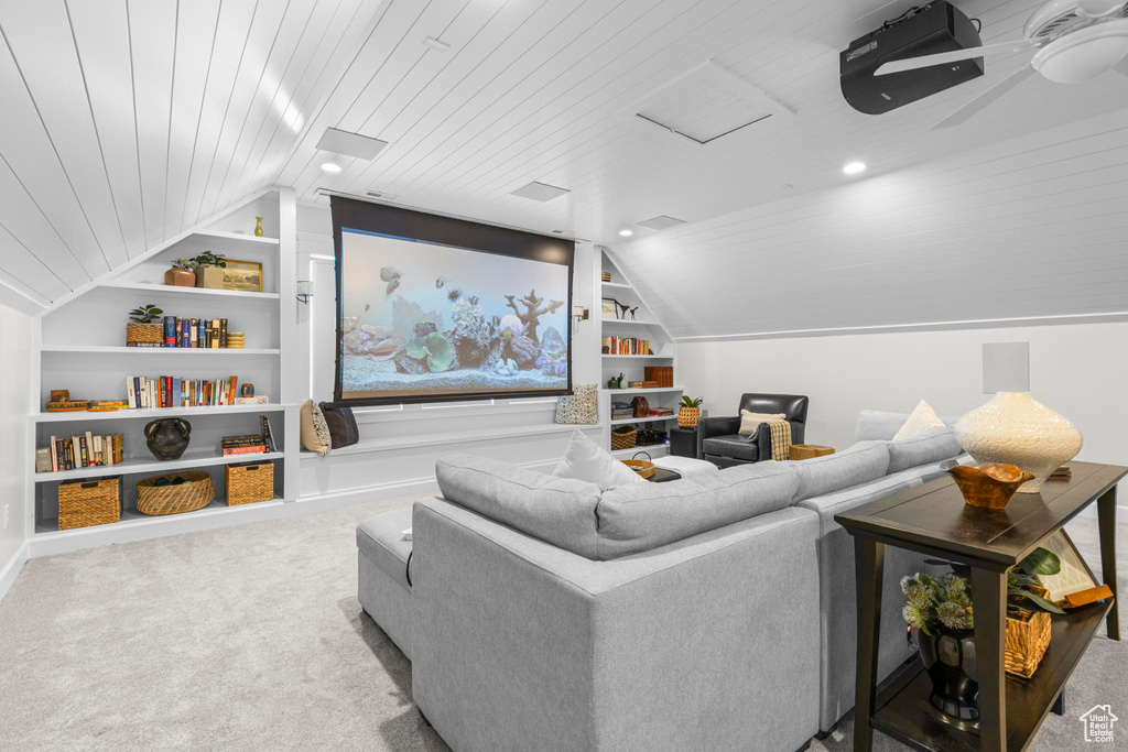 Carpeted cinema featuring built in features, wooden ceiling, lofted ceiling, and baseboards