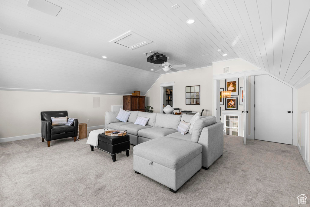 Living room featuring lofted ceiling, attic access, light carpet, wood ceiling, and recessed lighting