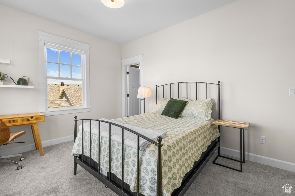 Bedroom with carpet floors and baseboards