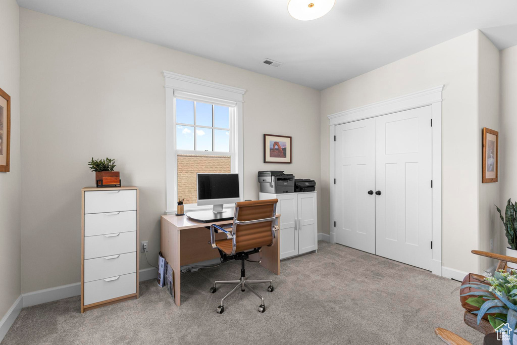 Office featuring light carpet and baseboards