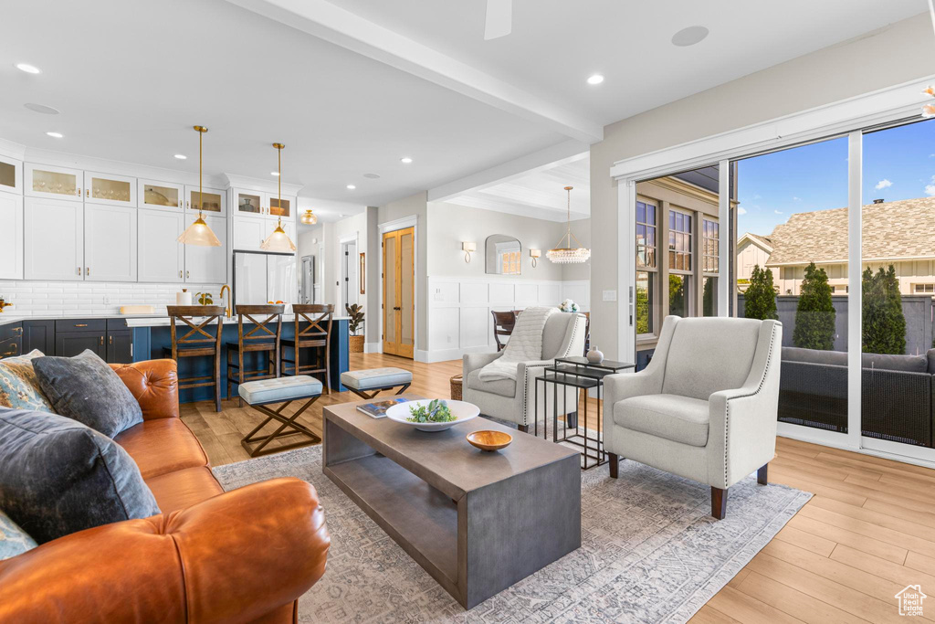 Living room with light wood-type flooring, recessed lighting, and ceiling fan