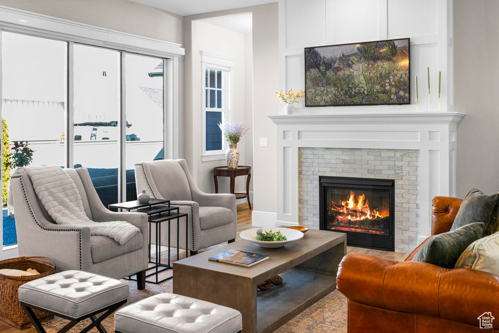 Sitting room with a fireplace and wood finished floors