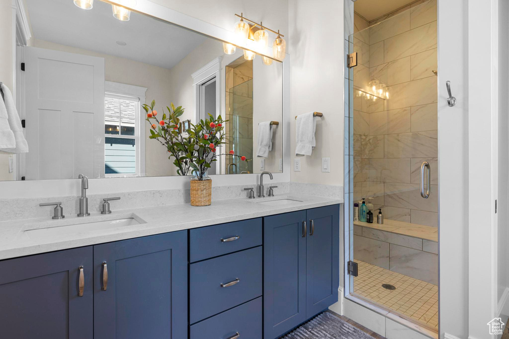 Bathroom with a stall shower and double vanity