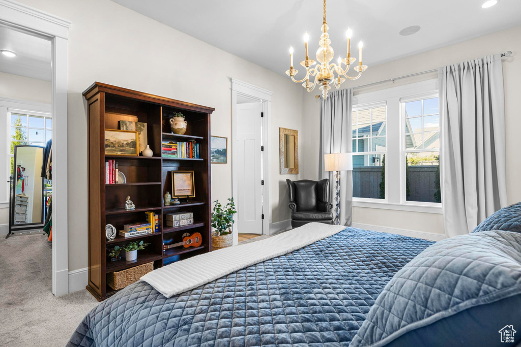 Carpeted bedroom featuring a chandelier, baseboards, and recessed lighting
