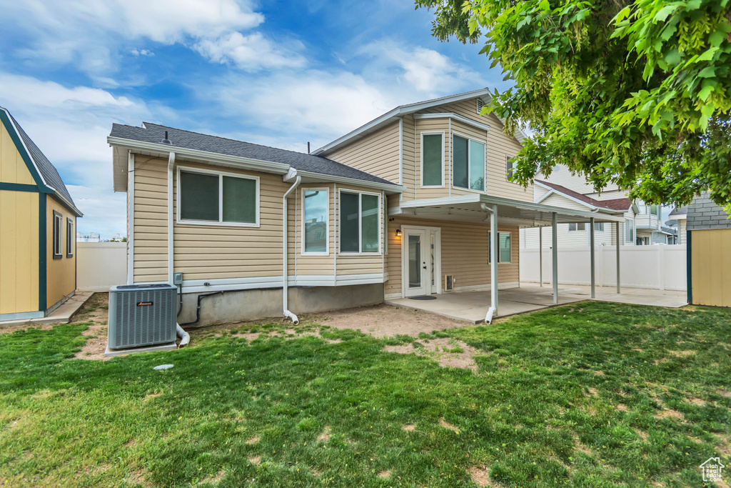 Rear view of house with central AC unit and a patio area