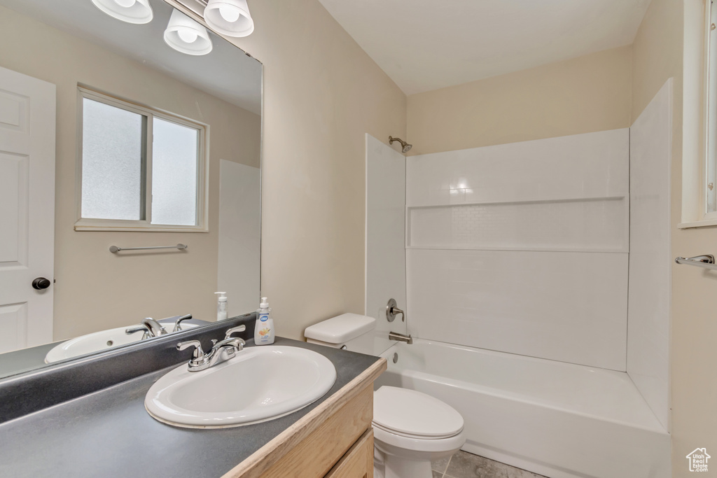 Full bathroom with toilet, vanity, and shower / bathtub combination
