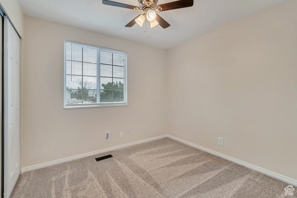 Unfurnished bedroom featuring carpet, baseboards, and a closet