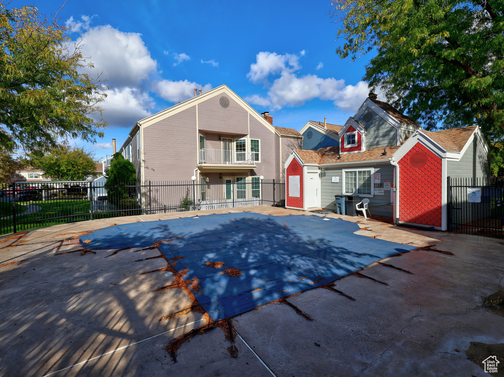 View of pool with fence and a patio