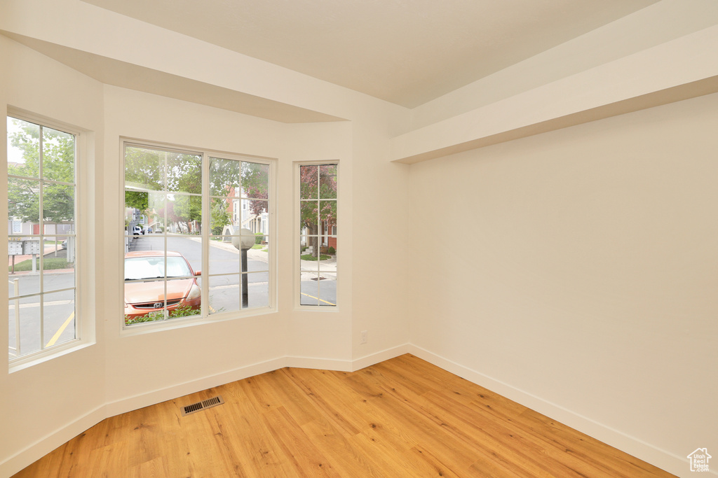 Unfurnished room with baseboards and light wood-style floors