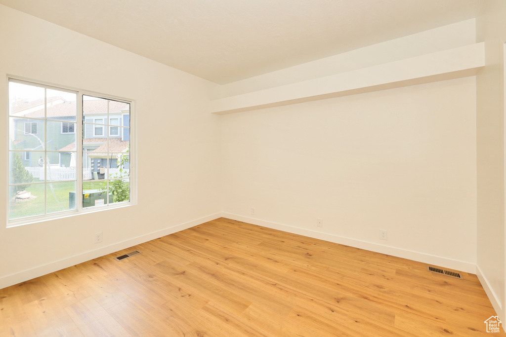 Empty room with baseboards and light wood finished floors