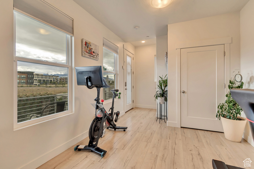 Workout room with wood finished floors, baseboards, and recessed lighting