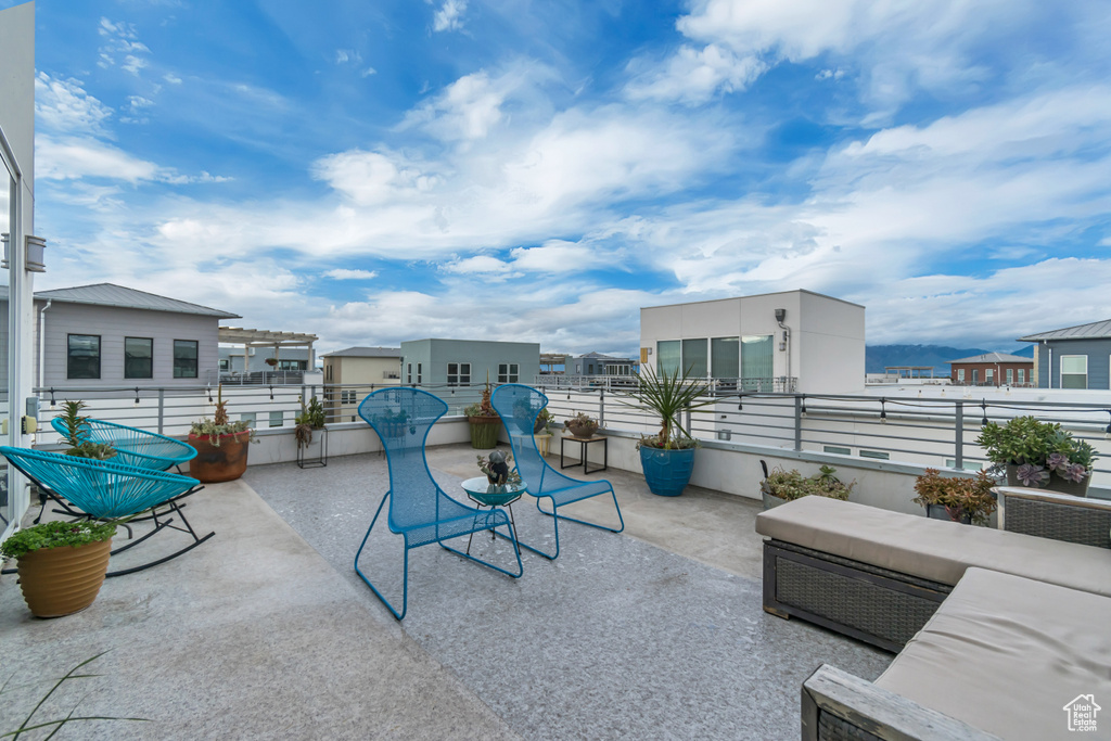 View of patio with a balcony
