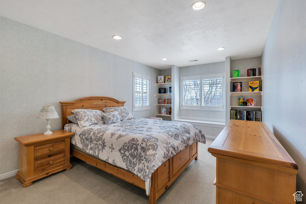 Bedroom featuring light carpet and recessed lighting